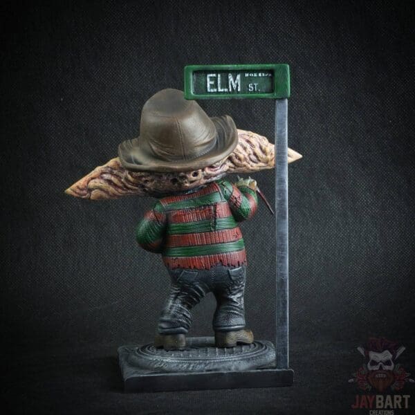 Horror figure near Elm Street sign.