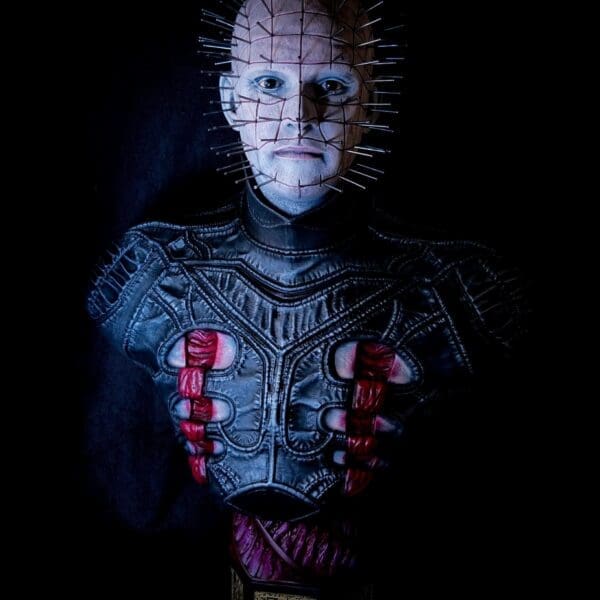 Horror figure with pins and dark attire.