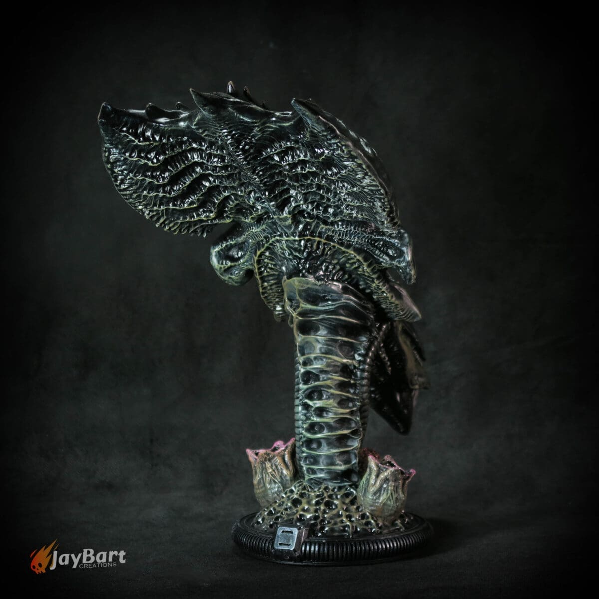 Alien creature sculpture with detailed textured design.