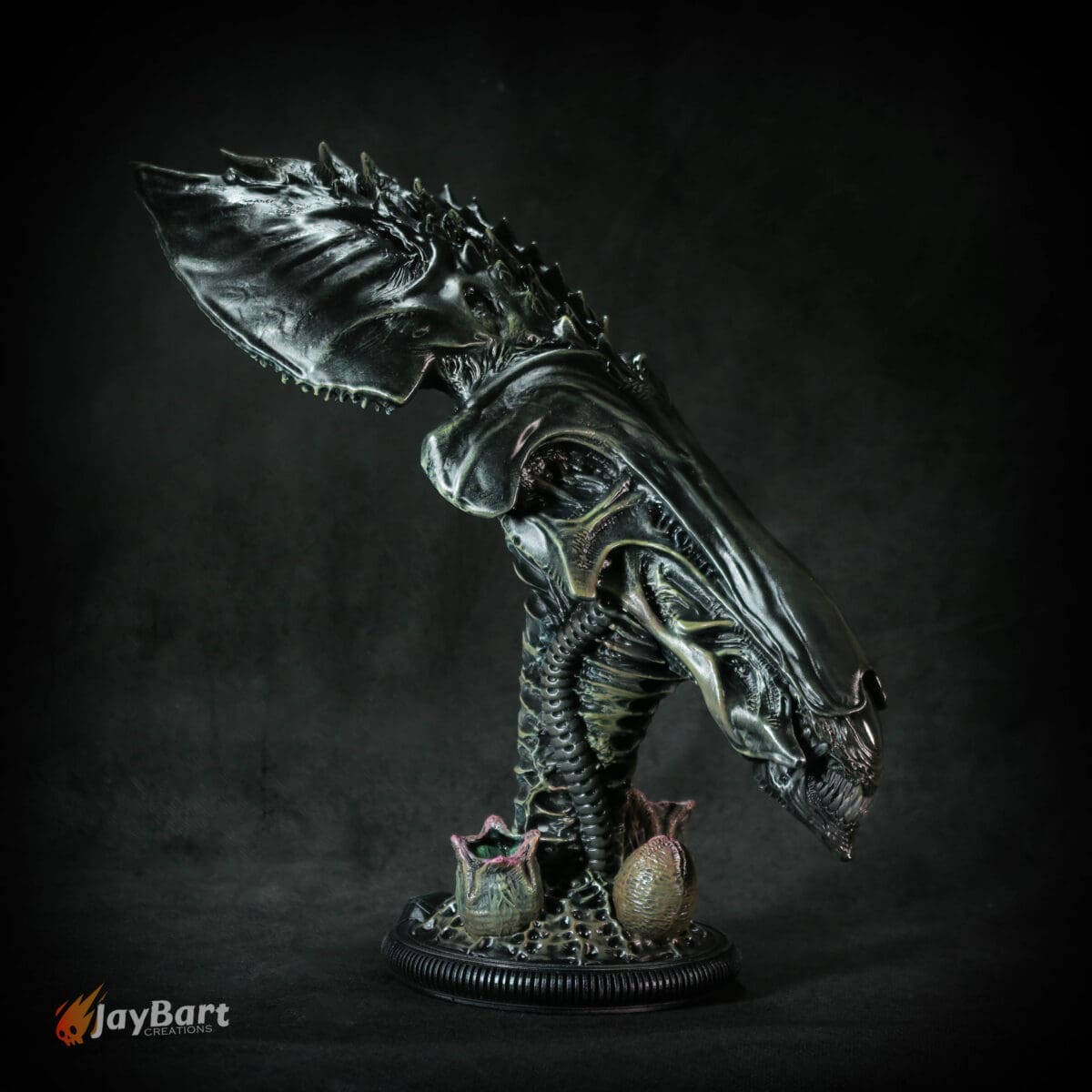 Alien sculpture with eggs and dark background