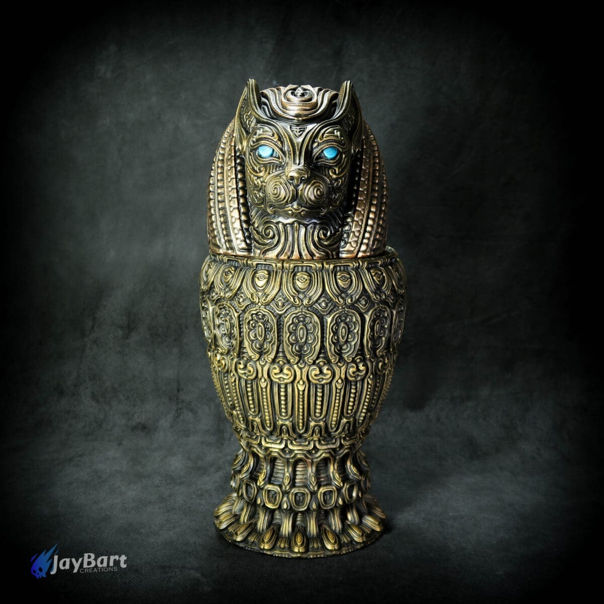 Ornate gold cat statue with blue eyes.