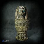 Ornate gold cat statue with blue eyes.