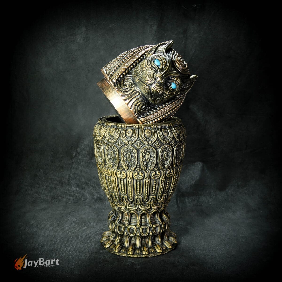 Intricate ornate vase with a tiger head lid.