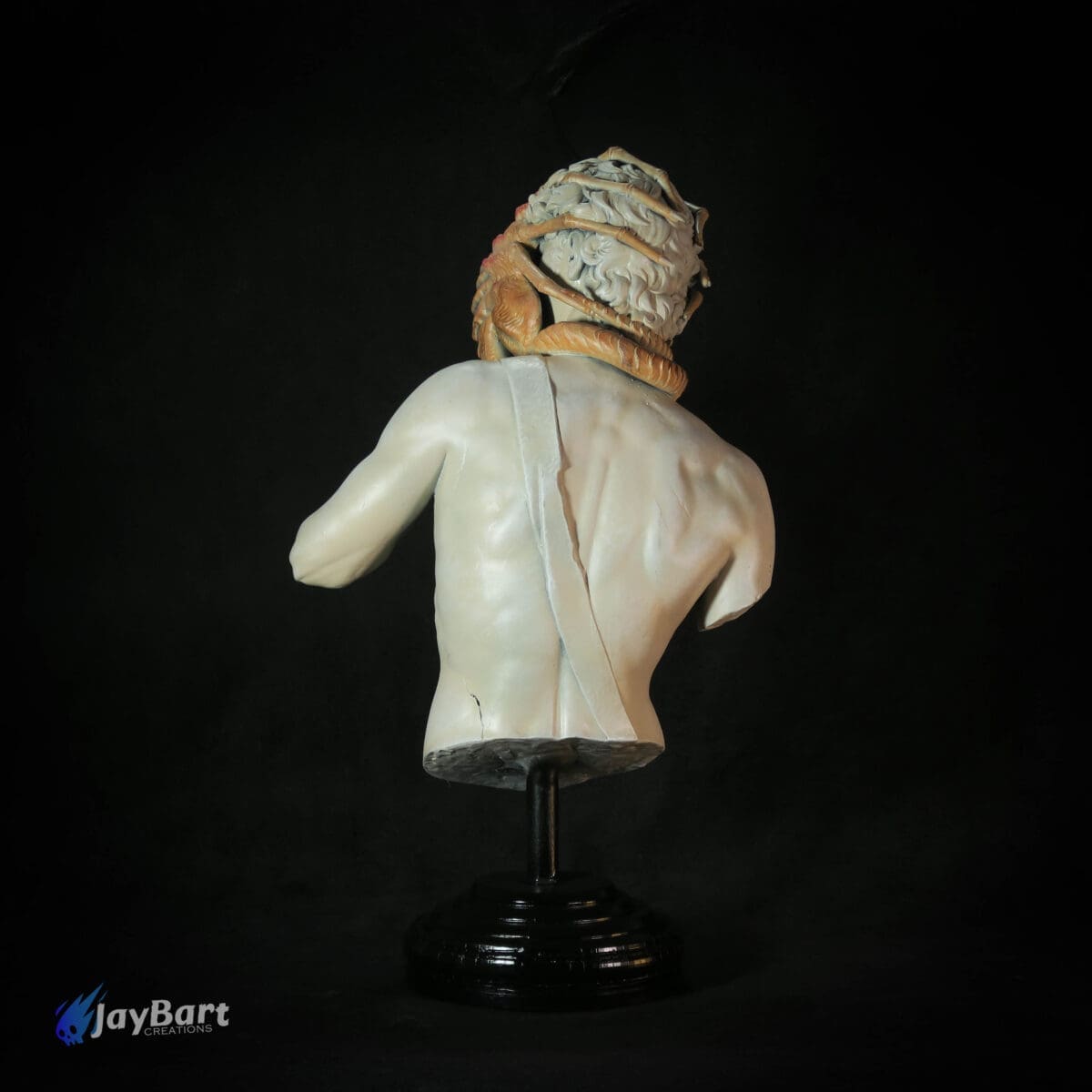Back view of ancient Greek bust sculpture on stand.