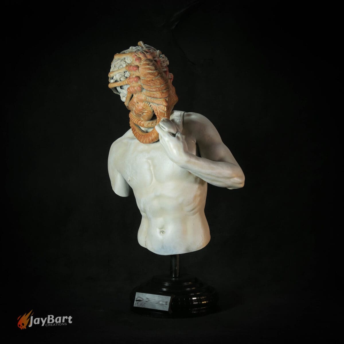 Sculpture of torso with surreal face detail.