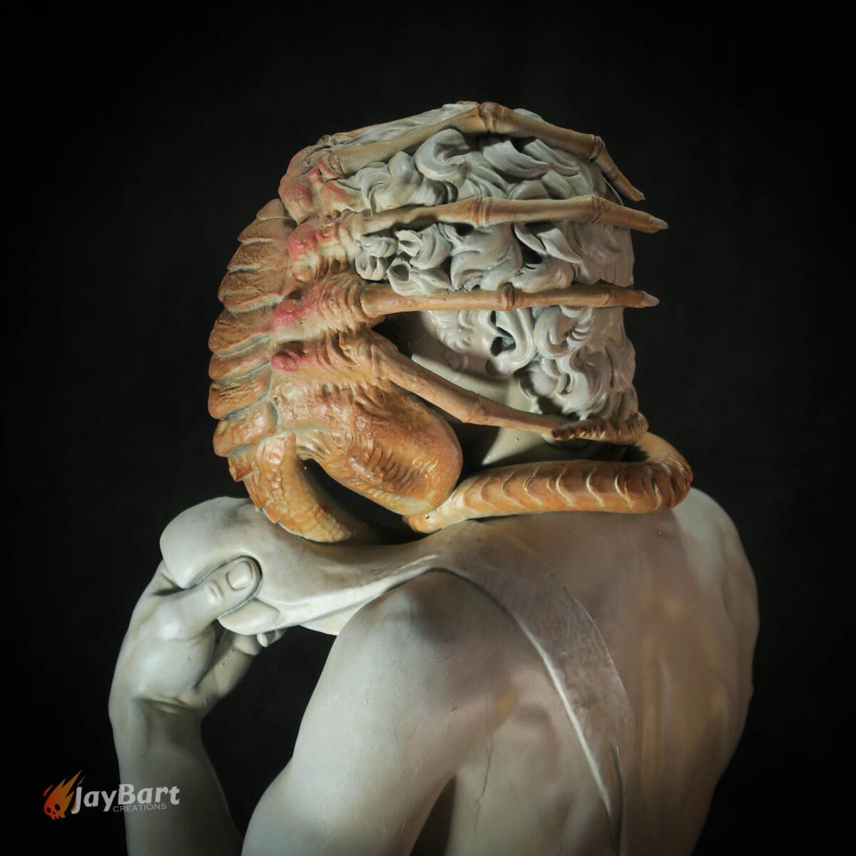 Classical statue with alien creature on face.