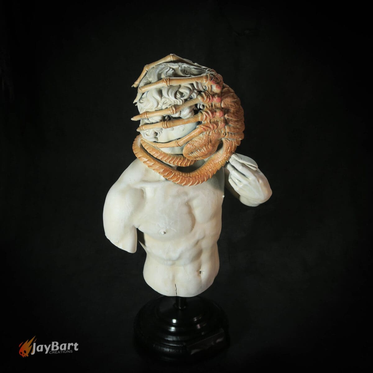 Sculpture of human torso with alien creature mask