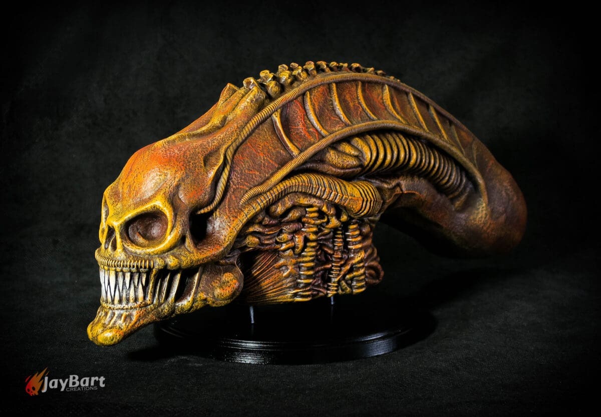 Futuristic alien skull sculpture on display.