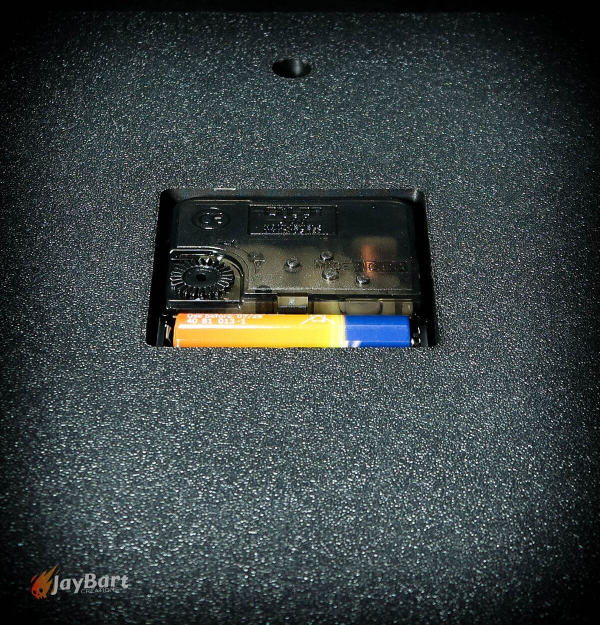 Battery compartment inside textured box.