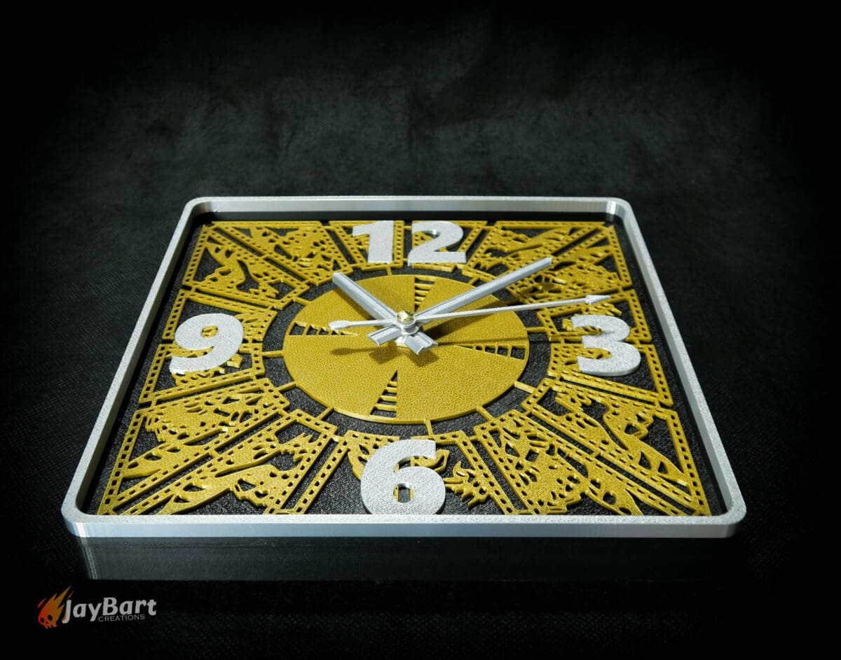 Square clock with gold intricate design on face.