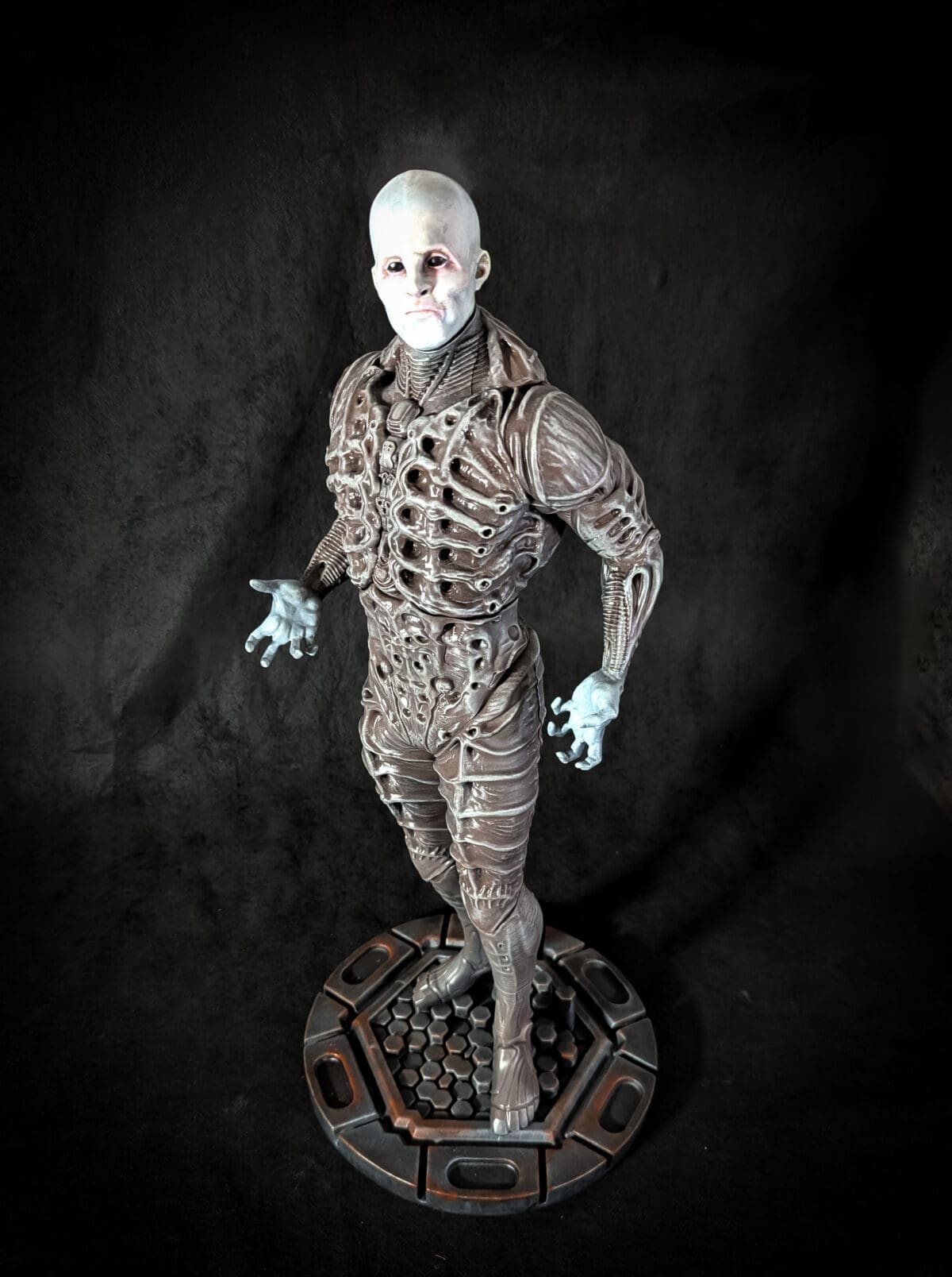 Alien humanoid statue in detailed armor.