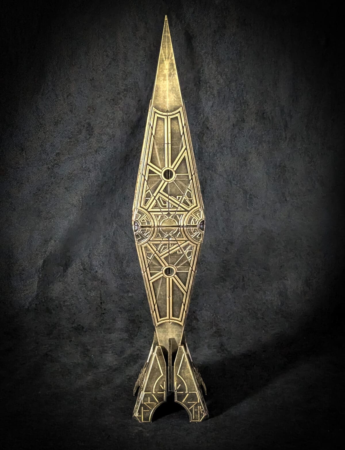 Geometric bronze sculpture with pointed shape.