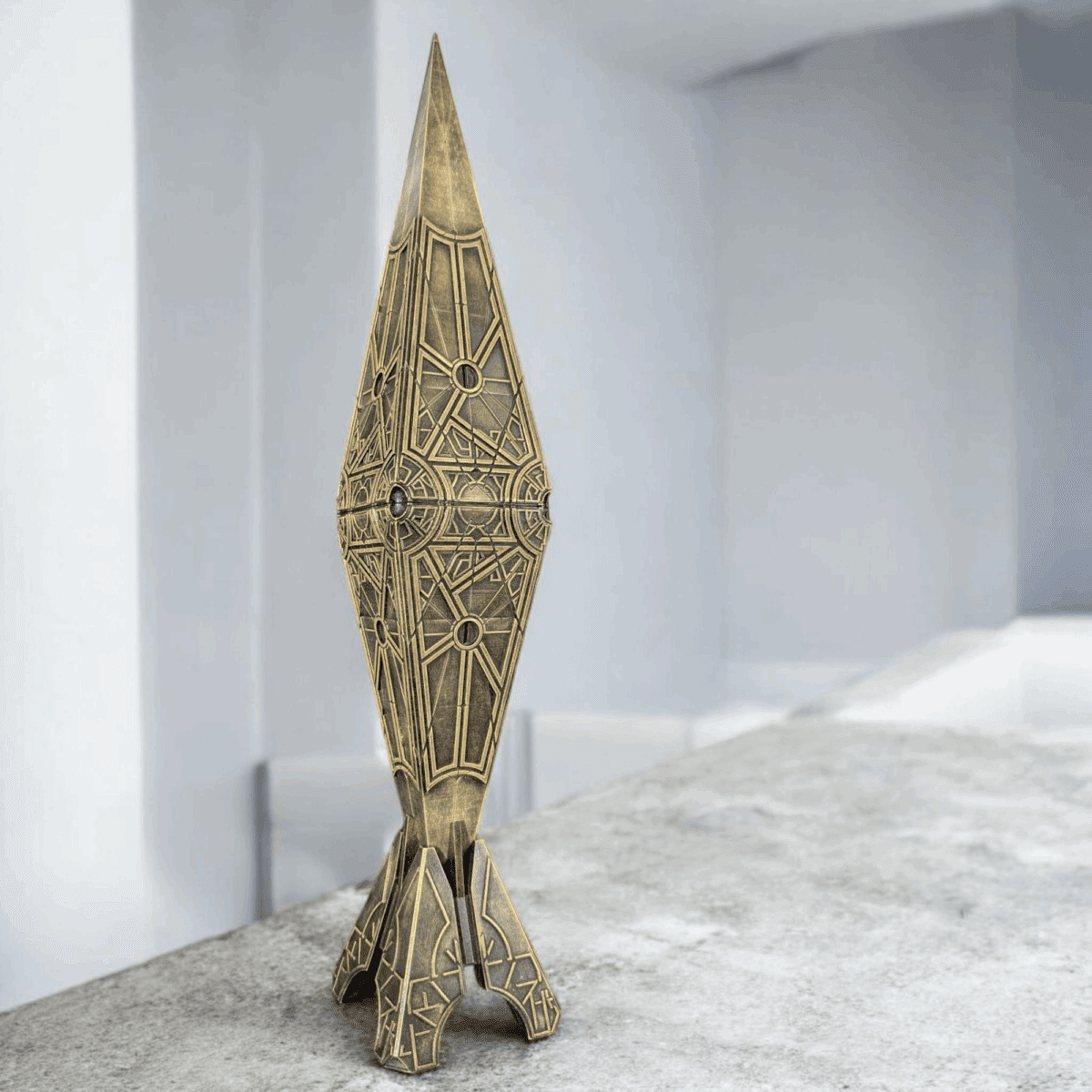 Intricate geometric sculpture on a concrete surface.