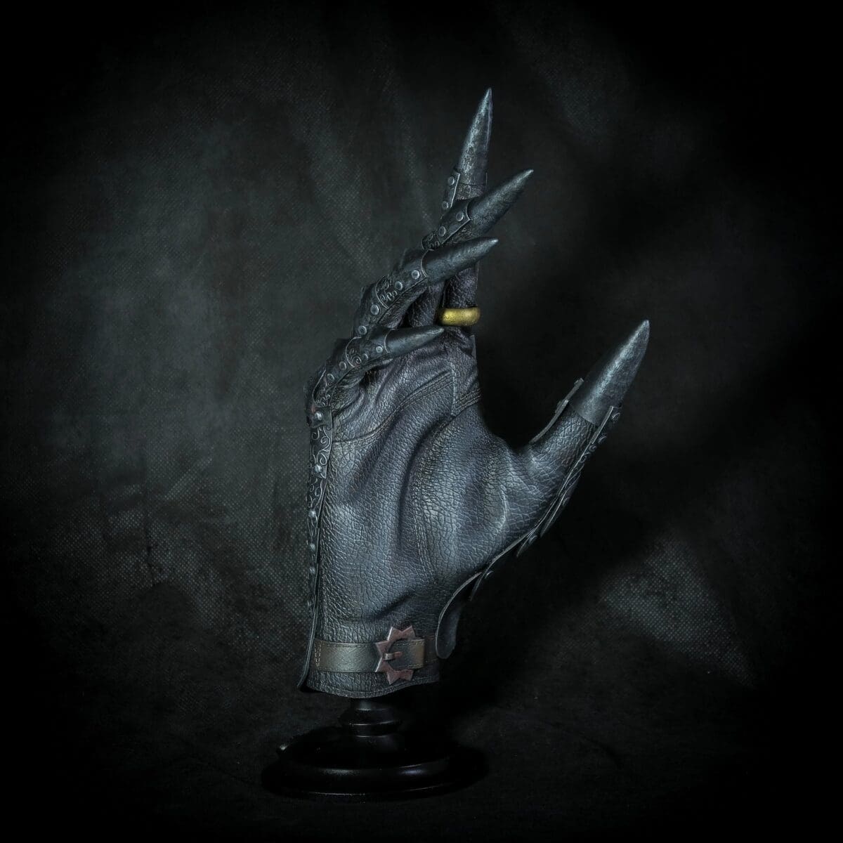 Decorative black glove with long metal claws