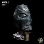 Dark metallic mask sculpture on wooden base.