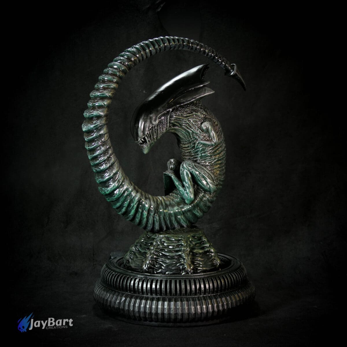 Alien sculpture with spiral tail on dark background.