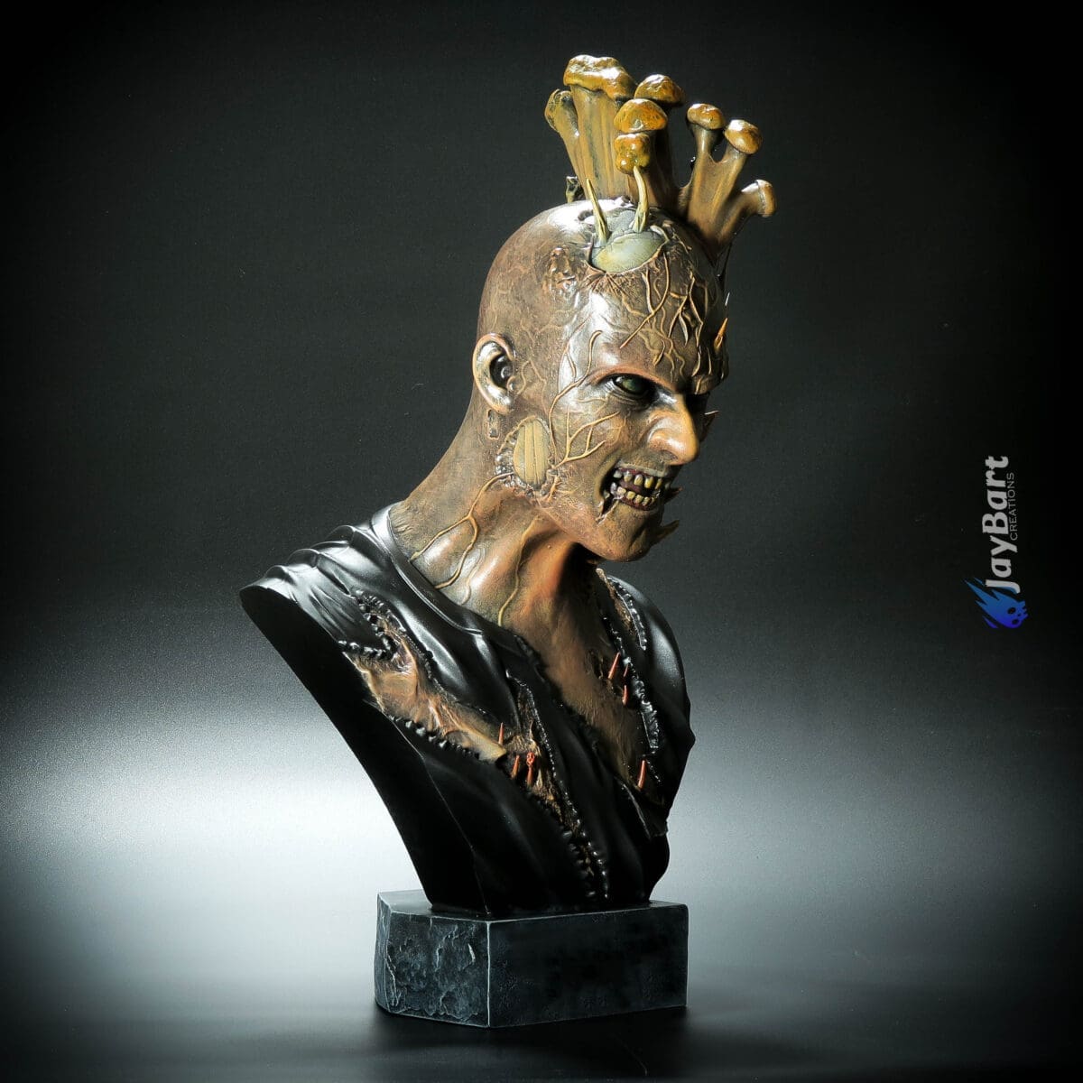 Sculpture of menacing figure with mushrooms on head.