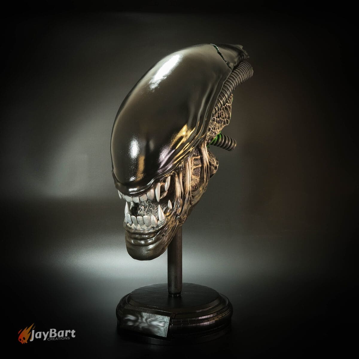Alien head sculpture on display stand