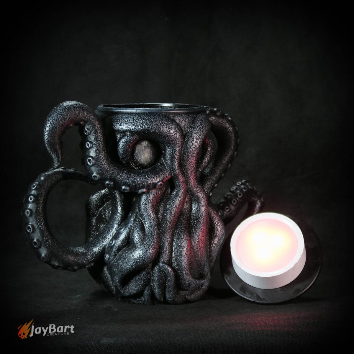 Octopus-shaped mug with glowing light beside it.
