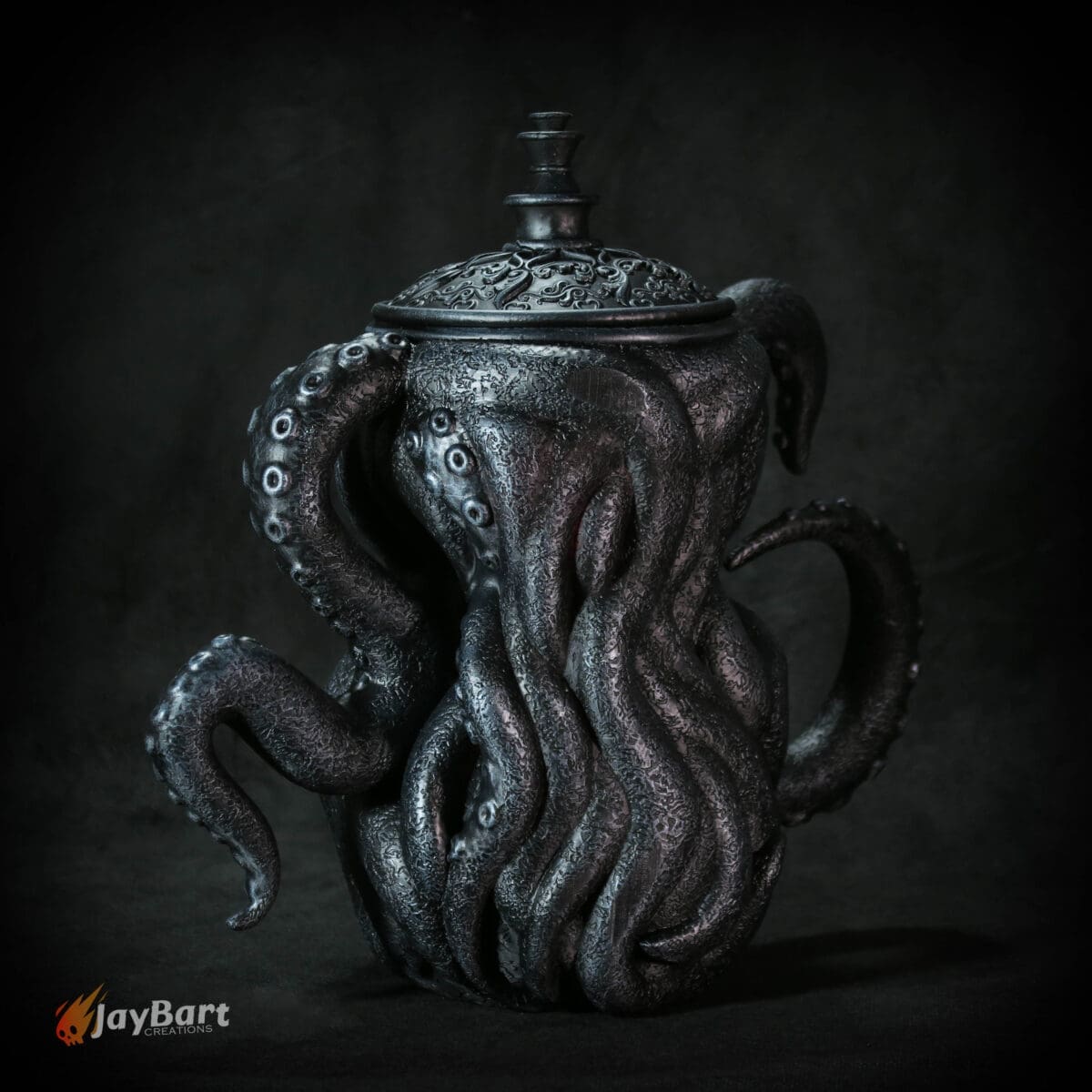 Tentacle-themed ceramic teapot with ornate lid.